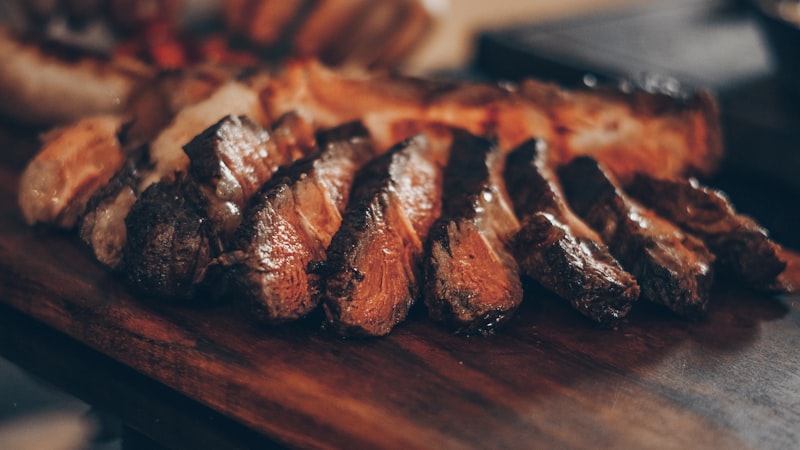 Sizzling golden-brown seared sirloin steak bites tossed in fresh parsley garlic butter on cutting board