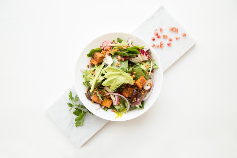 Nourishing grain bowl with roasted sweet potatoes, black beans, kale, and tahini drizzle